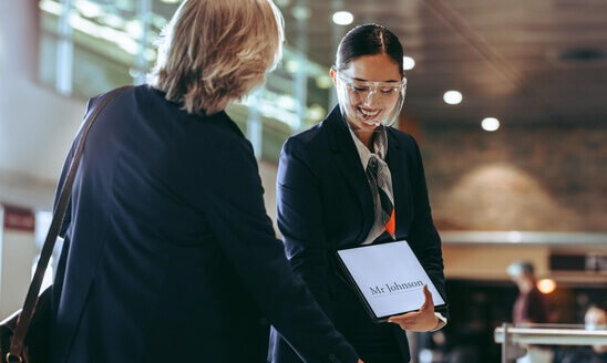 Our Services 12 np Chauffeur with a sign on airport arrival point receiving businessman 5rYYn0 free 1 e1696990193293