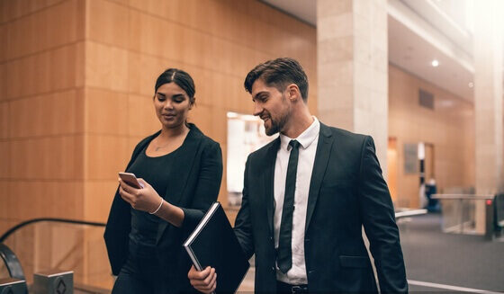 Our Services 9 np Two people in business suits walking together in airport terminal 56LzPb free e1696990059957